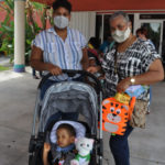 C -Baby Joshmanny, a Lighthouse client, with his mom and grandma