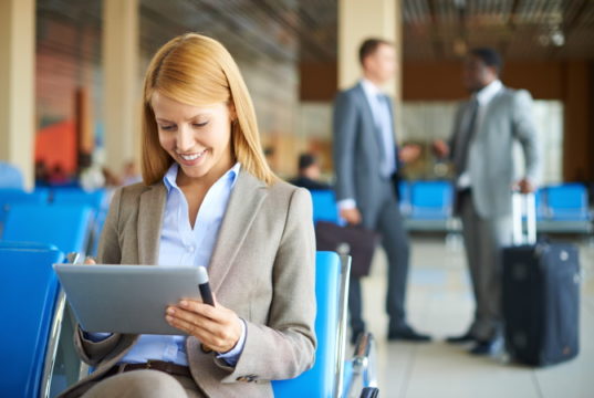 https://www.storyblocks.com/images/stock/happy-businesswoman-using-touchpad-with-her-partners-interacting-on-background-at-the-airport-bm3xu98dx_bj6gt2ulv