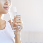 unrecognizable-woman-carrying-glass-water-mouth