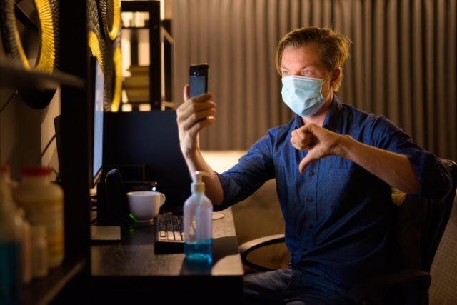 https://www.freepik.com/premium-photo/young-businessman-with-mask-giving-thumbs-down-video-calling-while-working-from-home-late-night_10273170.htm#page=1&query=covid%20phone%20thumbs%20down&position=2