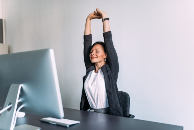 Break at work. Female office worker stretching hands. https://www.freepik.com/premium-photo/break-work-female-office-worker-stretching-hands_4673298.htm#page=1&query=desk%20stretching&position=43&from_view=search