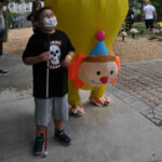 Emilio, who is blind, shares a laugh with an inflatable clown.