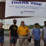 Jose Lopez Masso, Lighthouse of Broward’s Vice President of Strategic Initiatives and Development, poses with American Heritage students who volunteered at the event.