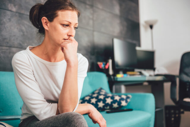 Sad woman sitting on a sofa in the living room https://www.freepik.com/premium-photo/sad-woman_5748354.htm