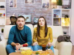 https://www.freepik.com/free-photo/couple-sitting-couch-cheering-up-while-watching-sports-tv-eating-junk-food-with-their-cat-them_21017161.htm?query=person%20snacking