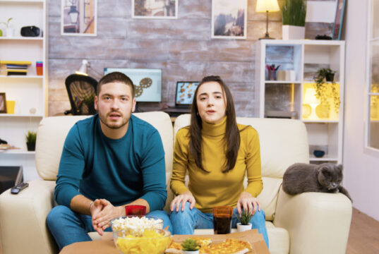 https://www.freepik.com/free-photo/couple-sitting-couch-cheering-up-while-watching-sports-tv-eating-junk-food-with-their-cat-them_21017161.htm?query=person%20snacking