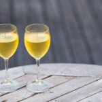 two glasses of tasty white wine at sunset on summer
