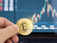 https://www.vecteezy.com/photo/5464655-hand-holding-a-bitcoin-coin-and-chart-on-laptop-display-at-background-cryptocurrency-trading-or-investment-concept