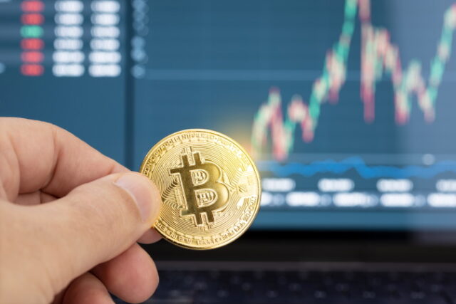 https://www.vecteezy.com/photo/5464655-hand-holding-a-bitcoin-coin-and-chart-on-laptop-display-at-background-cryptocurrency-trading-or-investment-concept