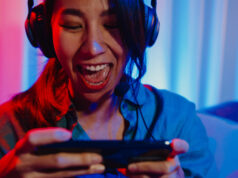 https://www.vecteezy.com/photo/3652449-happy-asia-girl-gamer-wear-headphone-competition-video-game-online-with-smartphone-excited-talk-with-friend-sit-on-couch-in-colorful-neon-lights-living-room-at-home-home-quarantine-activity-concept