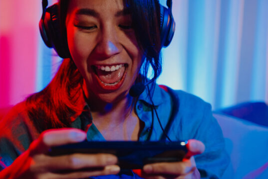 https://www.vecteezy.com/photo/3652449-happy-asia-girl-gamer-wear-headphone-competition-video-game-online-with-smartphone-excited-talk-with-friend-sit-on-couch-in-colorful-neon-lights-living-room-at-home-home-quarantine-activity-concept