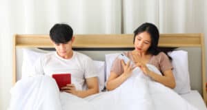 https://www.vecteezy.com/photo/7185897-asian-couple-looking-at-each-other-smartphone-for-social-media-while-laying-down-in-the-bed-planning-for-their-upcoming-wedding