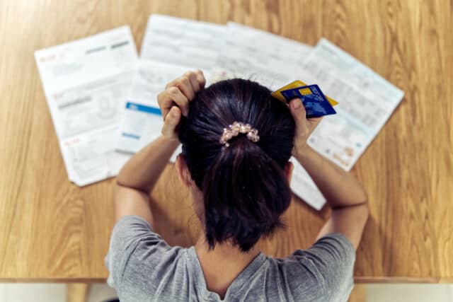 https://www.freepik.com/premium-photo/top-view-stressed-young-sitting-asian-woman-hands-holding-head-worry-about-find-money-pay-credit-card-debt-all-loan-bills_4545002.htm#query=debt&position=7&from_view=search