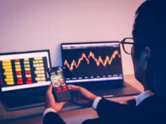 https://www.vecteezy.com/photo/7311896-businessman-using-cell-phone-with-statistic-graph-of-stock-market-analysis-on-laptop-screen-and-technology