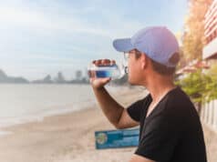 https://www.vecteezy.com/photo/7311911-man-drinking-water-from-a-bottle-sit-outside-next-to-the-beach