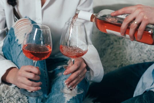 https://www.vecteezy.com/photo/3389305-a-man-fills-glasses-with-rose-wine-from-a-bottle