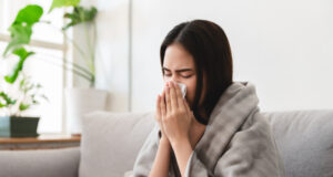 https://www.freepik.com/premium-photo/sick-asian-young-woman-sneezing-into-tissue-paper-while-covered-with-blanket-sitting-sofa-living-room_5611628.htm#query=flu&position=45&from_view=search