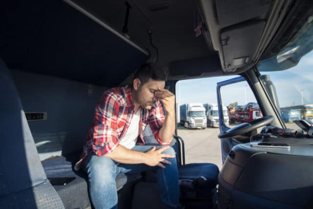 Truck driver sitting in his truck cabin feeling worried and upset. https://www.freepik.com/free-photo/truck-driver-sitting-his-truck-cabin-feeling-worried-upset_11450895.htm#query=truckers&position=22&from_view=search