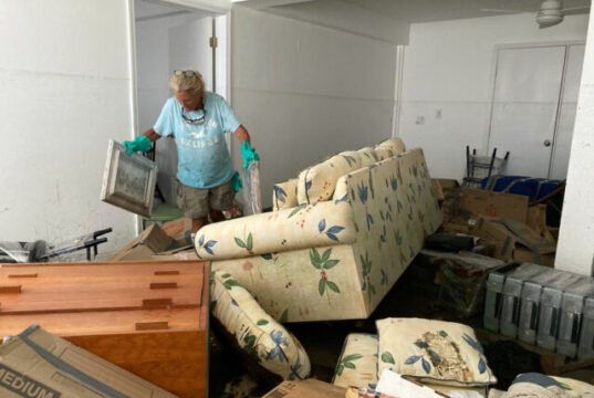 Resident Pamela Brislin who has lived on Sanibel Island since 2020 cleans up the damage from Hurricane Ian, Thursday, Oct. 6, 2022, in Sanibel Island, Fla. Residents of Florida’s Gulf Coast barrier islands are returning to assess the damage from Hurricane Ian, despite limited access to some areas. (AP Photo/Scott Smith)