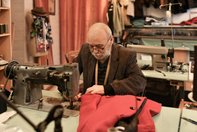 A gray-haired man works at a sewing machine https://www.freepik.com/premium-photo/grayhaired-man-works-sewing-machine-his-atelier_30701953.htm#query=retiree%20working&position=33&from_view=search&track=sph