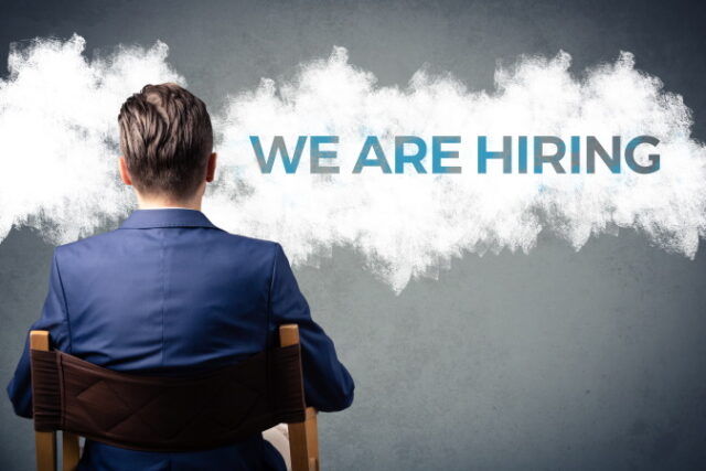 https://www.vecteezy.com/photo/11626978-we-are-hiring-confident-businessman-with-arms-crossed-standing-next-to-sign-on-the-wall-job-search-concept