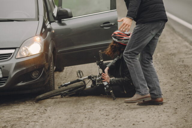 The woman crashed into the car. Girl in a helmet. https://www.freepik.com/free-photo/woman-crashed-into-car-girl-helmet_12036439.htm#query=bicycle%20accident&position=8&from_view=search&track=sph