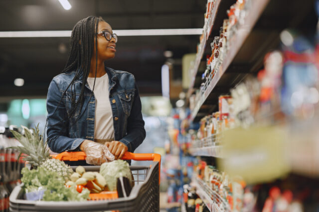 African woman with shopping cart. Girl in a supermarket. https://www.freepik.com/free-photo/woman-shopping-vegetables-supermarket_9658772.htm#query=food%20shopping&position=10&from_view=search&track=sph
