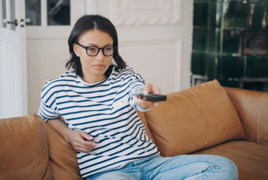 https://www.vecteezy.com/photo/11100753-bored-young-caucasian-woman-holding-remote-controller-and-watching-boring-movie-or-tv-show