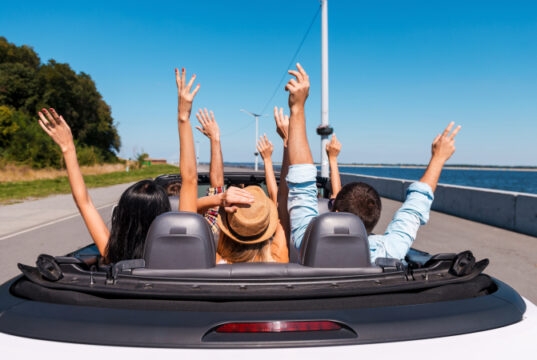 https://www.vecteezy.com/photo/13291560-just-fun-and-road-ahead-rear-view-of-young-happy-people-enjoying-road-trip-in-their-convertible-and-raising-their-arms-up