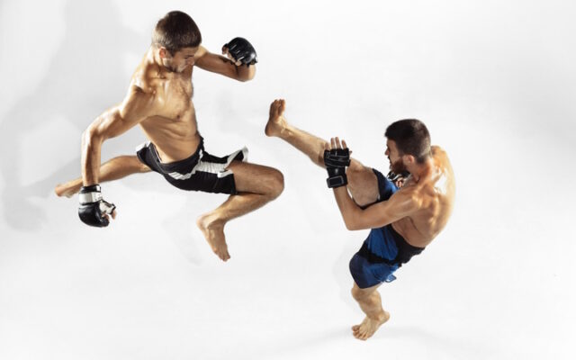 Two professional MMA fighters boxing isolated on white studio background, dynamic and motion. Top view https://www.freepik.com/free-photo/two-professional-mma-fighters-boxing-isolated-white-studio_10190818.htm#query=UFC&position=15&from_view=search&track=sph