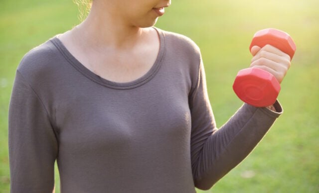 Asian female in grey sportswear is lifting dumbbell. https://www.freepik.com/premium-photo/asian-female-grey-sportswear-is-lifting-dumbbell_2287233.htm#query=heart%20exercise&position=9&from_view=search&track=ais