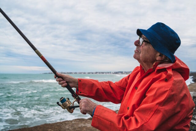 Senior man fishing in the sea. https://www.freepik.com/free-photo/portrait-senior-man-fishing-sea-enjoying-life-fishing-sport-concept_10104183.htm#query=outer%20banks%20fishing&position=12&from_view=search&track=ais
