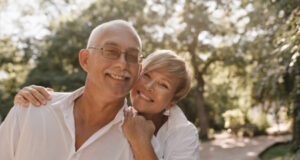 https://www.freepik.com/free-photo/smiling-old-man-with-grey-hair-mustache-glasses-light-shirt-hugging-with-blonde-woman-white-clothes-park_13214698.htm#query=retire&position=16&from_view=search&track=sph