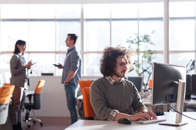 businessman working using a computer in startup office Asset ID: SBI-322081819