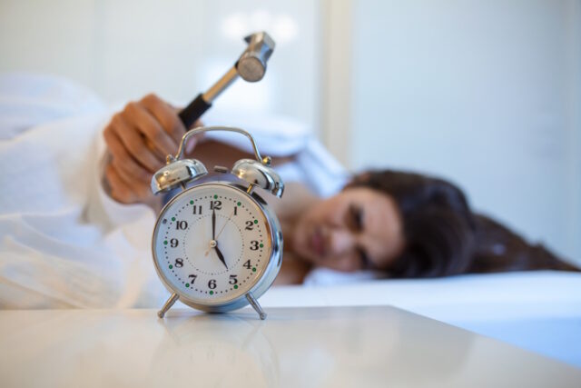 Young woman tries to break the alarm clock with hammer, Destroy the Clock. Girl lying in bed turning off an alarm clock with hammer in the morning at 5am. https://www.freepik.com/free-photo/young-woman-tries-break-alarm-clock-with-hammer-destroy-clock-girl-lying-bed-turning-off-alarm-clock-with-hammer-morning-5am_27155322.htm#query=restless%20sleep&position=9&from_view=search&track=ais