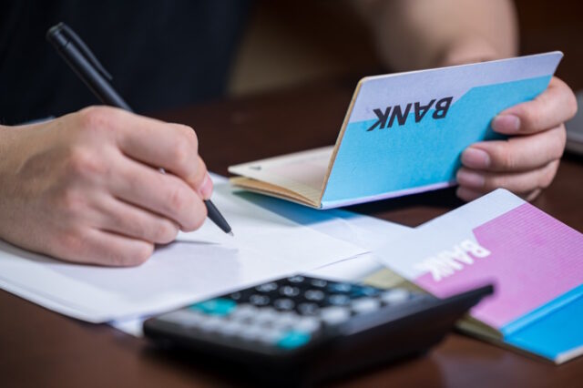 The hands of the men who are holding a bank passbook and weaving a budget. https://www.freepik.com/premium-photo/hands-men-who-are-holding-bank-passbook-weaving-budget_9850704.htm#page=2&query=bank%20account&position=11&from_view=search&track=ais