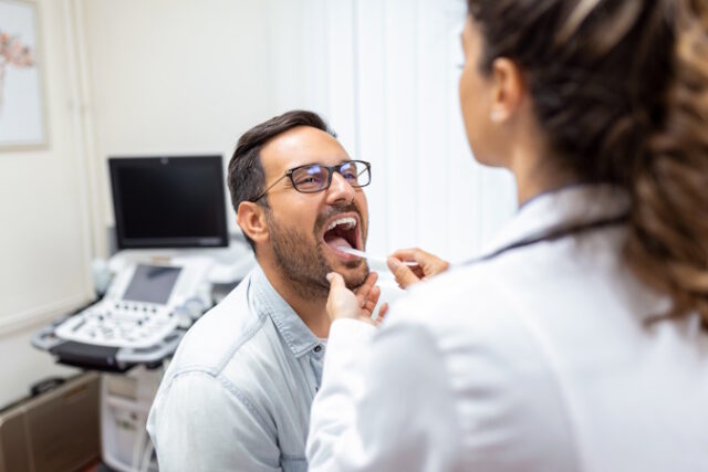 https://www.freepik.com/free-photo/doctor-using-inspection-spatula-examine-patient-throat-ent-doctor-doing-throat-exam-patient-opened-his-mouth-throat-checkup_28001807.htm#query=tonsils&position=4&from_view=search&track=sph