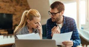 https://www.freepik.com/free-photo/young-displeased-couple-talking-while-analyzing-their-home-finances_25750290.htm#query=couple%20bills&position=10&from_view=search&track=ais