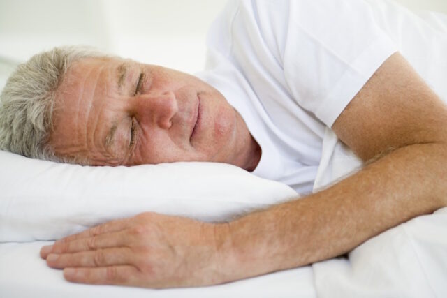 Man lying in bed sleeping Asset ID: SBI-301057204