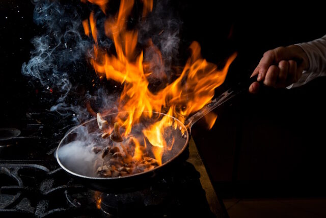 Side view mushroom frying with stove and fire and human hand in pan on black background By Beth JoJack on June 16, 2023 — Fact checked by Alexandra Sanfins, Ph.D.