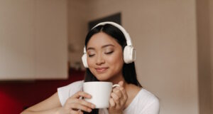 https://www.freepik.com/free-photo/attractive-asian-woman-headphones-inhale-aroma-tea-holding-cup-smiling_13400291.htm#query=coffee%20and%20music&position=30&from_view=search&track=country_rows_v1