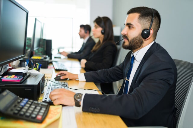 Sales representative talking with a customer https://www.freepik.com/free-photo/attractive-latin-executive-offering-customer-service-with-headset-offering-tech-support-busy-call-center_27507417.htm#query=telemarketers&position=0&from_view=search&track=sph