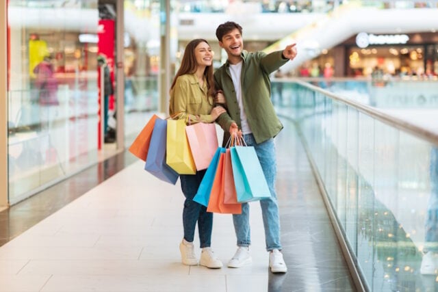 Couple With Colorful Bags Shopping Pointing Finger Aside In Mall https://www.freepik.com/premium-photo/couple-with-colorful-bags-shopping-pointing-finger-aside-mall_27910945.htm#query=women%20men%20shopping&position=46&from_view=search&track=ais