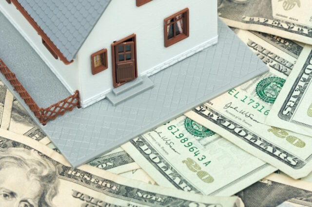 Home and Money on a Money Background https://www.vecteezy.com/photo/16475802-home-and-money