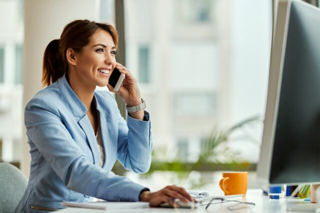 Happy businesswoman talking on the phone while using computer in https://www.freepik.com/free-photo/young-happy-businesswoman-working-desktop-pc-communicating-mobile-phone-office_26144178.htm#page=2&query=person%20phone%20broker&position=2&from_view=search&track=ais