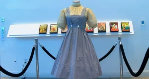 A blue and white checked gingham dress, worn by Judy Garland in the “Wizard of Oz,” hangs on display, Monday, April 25, 2022, at Bonhams in New York. Katie Vasquez | AP
