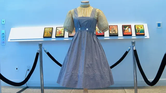 A blue and white checked gingham dress, worn by Judy Garland in the “Wizard of Oz,” hangs on display, Monday, April 25, 2022, at Bonhams in New York. Katie Vasquez | AP