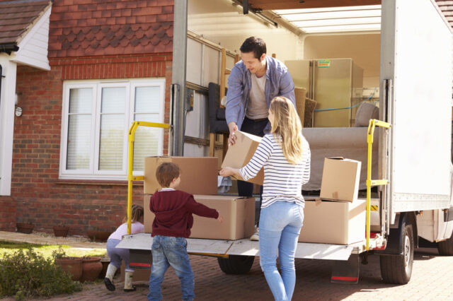 https://www.dreamstime.com/stock-photo-family-unpacking-moving-boxes-removal-truck-image79801635