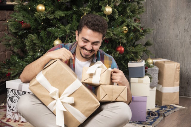 Handsome smiling man with his presents https://www.freepik.com/free-photo/handsome-smiling-man-with-his-presents_16935677.htm#query=person%20opened%20christmas%20gifts&position=24&from_view=search&track=ais&uuid=50249151-87fb-4219-8a98-bed9c576f101