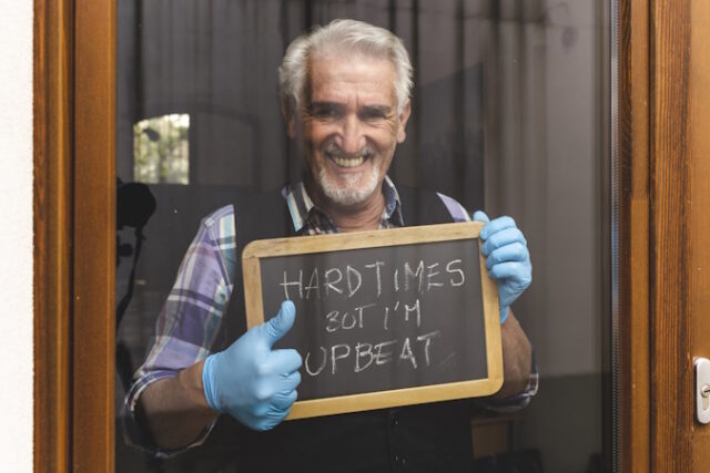 single mature man quarantined by coronavirus at window shows a m https://www.freepik.com/premium-photo/portrait-smiling-man-standing-outdoors_117405305.htm#query=elderly%20help%20wanted%20sign&position=38&from_view=search&track=ais&uuid=d339dfd6-45c7-4b5c-85c5-3a143bda8de4
